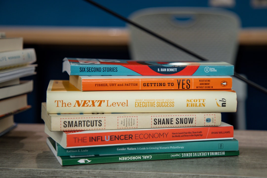 A stack of business books, marketing books, and a storytelling book.
